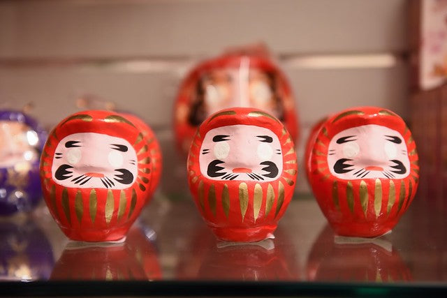 Three red daruma dolls