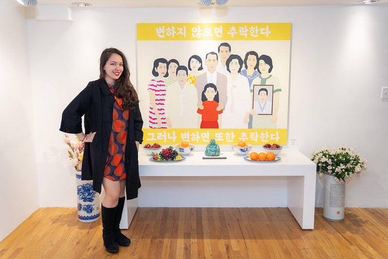 Artist Julia Chon beside her painting and altar table