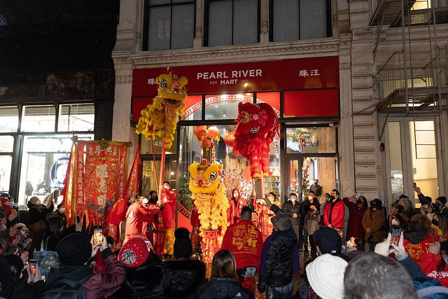 Lion dancers on stilts in front of Pearl River Mart in SoHo