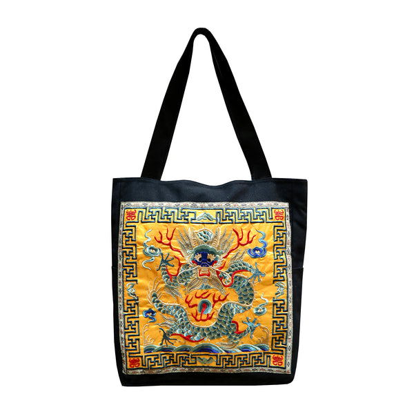 Black tote bag with Embroidered Blue Dragon design on Yellow background