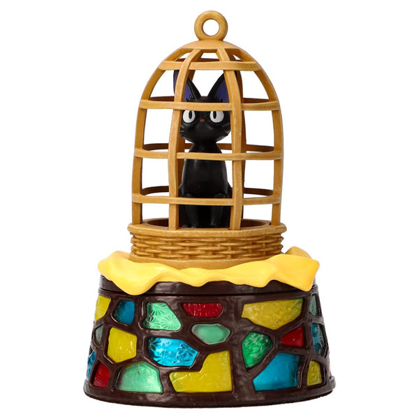 Jiji figurine in cage.