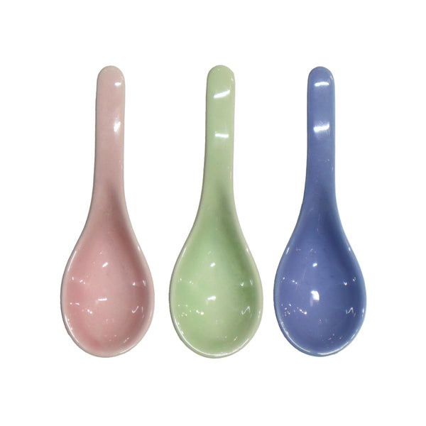 Ceramic soup spoons in pink, green, and blue
